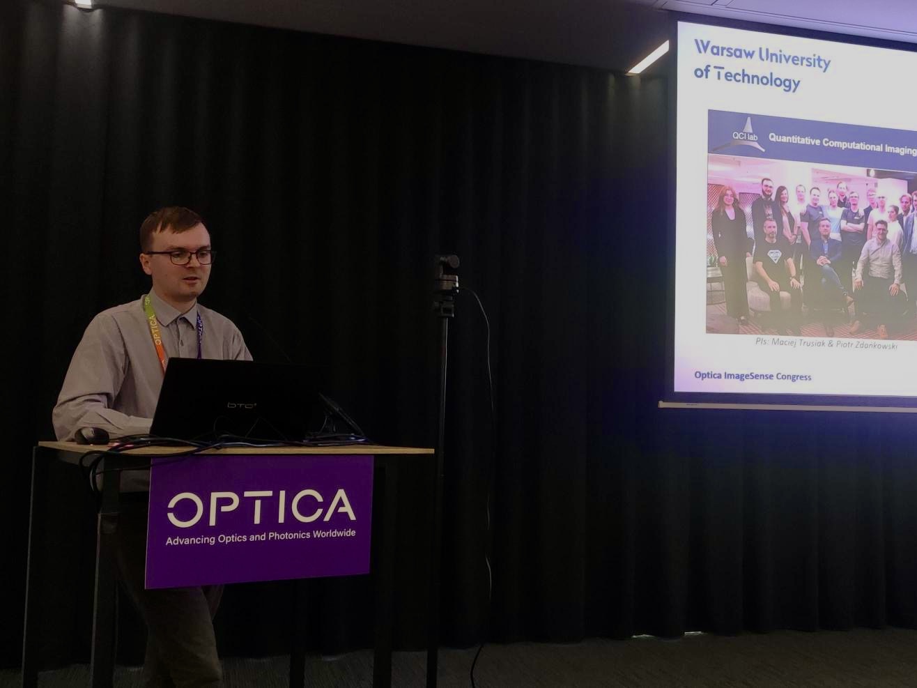 Mikołaj delivering his talk